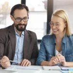 Close-up of an estate planning advisor reviewing legal documents with a client in a professional office setting.