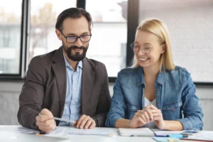 Close-up of an estate planning advisor reviewing legal documents with a client in a professional office setting.