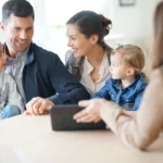 Financial advisor discussing estate planning documents with a family in an office setting.