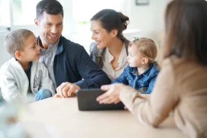 Financial advisor discussing estate planning documents with a family in an office setting.